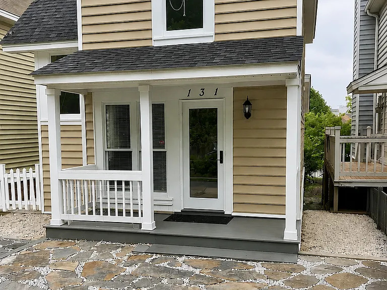 Back of home with keyless entry and two parking spaces.