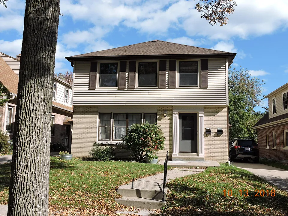 Street view with great side drive access to garage and parki