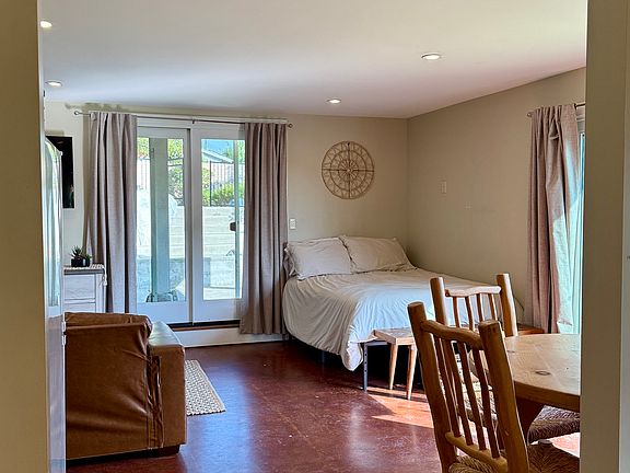 A view from the vanity sink area into the living space and second sliding door entrance/exit.