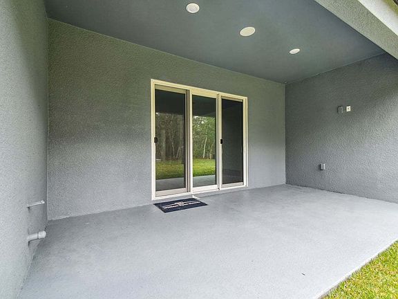 Sapphire new construction quick move-in home 1285 Kelsa Anne Dr. rear covered lanai at Whiting Estat