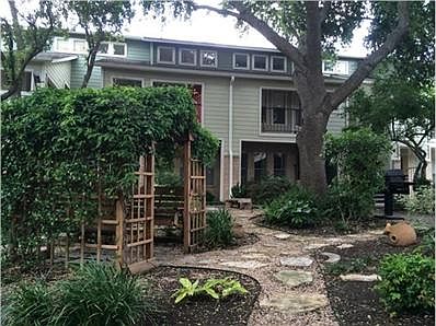 Peaceful, courtyard garden with tall oaks.