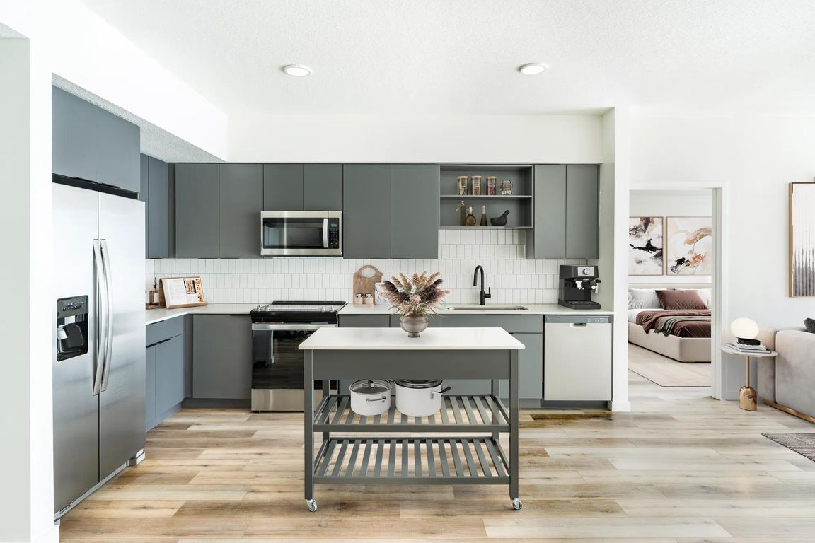 A refined kitchen paired with a movable island, bringing flexible style and function to everyday living at Modera Encore in Tampa.