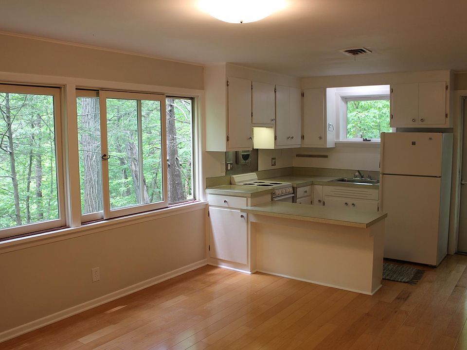 The kitchen with breakfast bar is open to the living room. Sunset views through the woods every night!