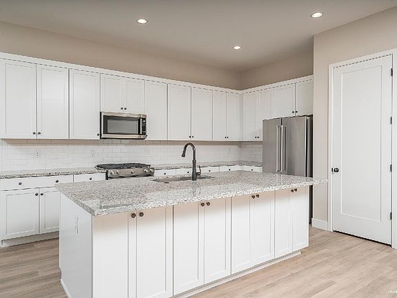 Beautiful White Kitchen With Stainless Steel Appliances