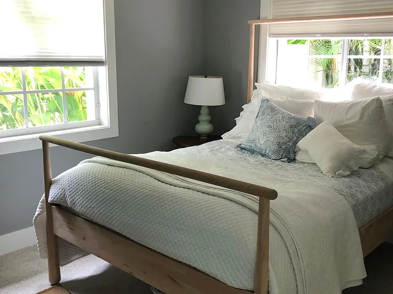 Bedroom with queen bed. Bathroom en-suite. Windows overlook front and side gardens.