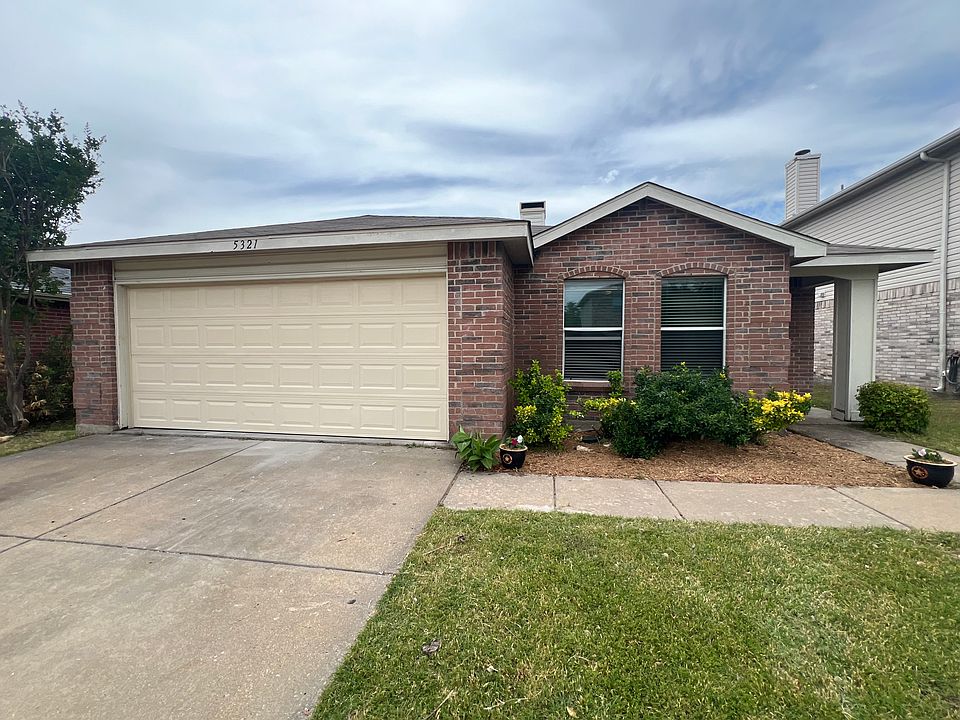Welcome to your new home, featuring an inviting entrance and beautifully landscaped yard.
