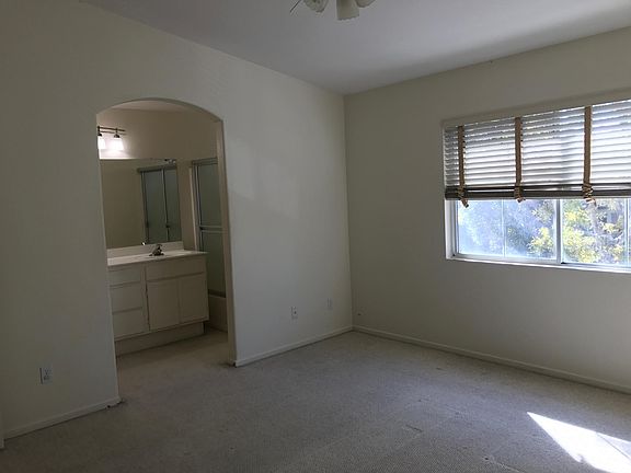 Master Bedroom wide windows, full bathroom, and spacious wal