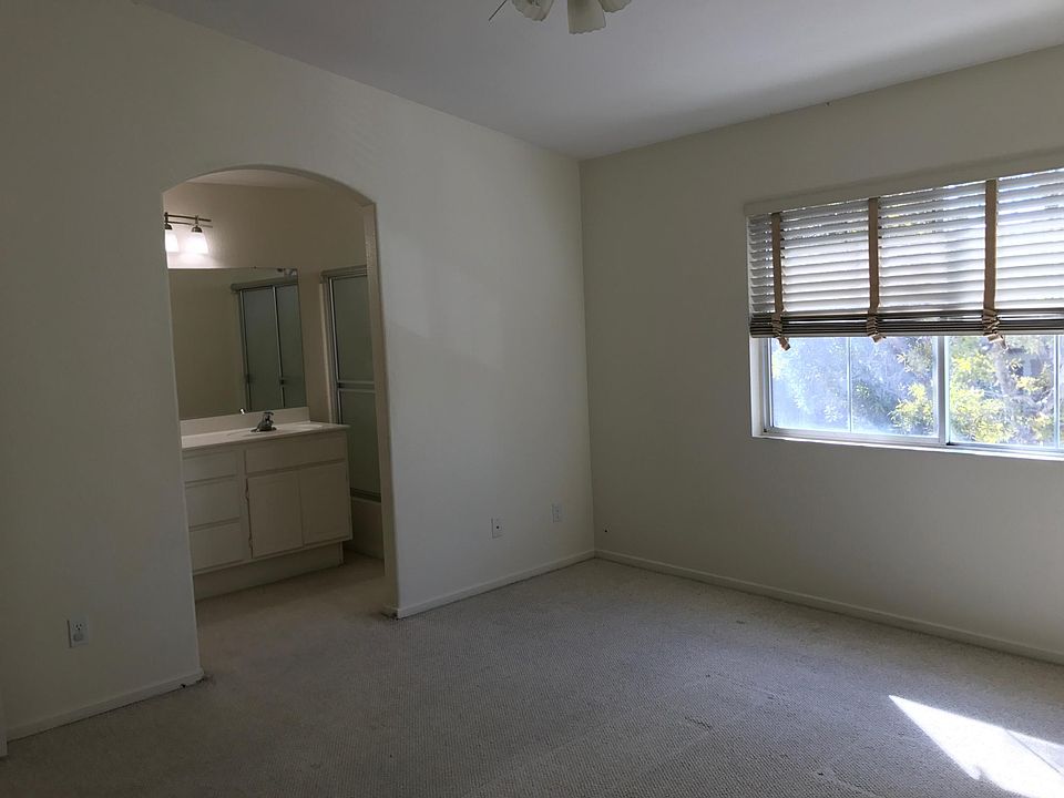 Master Bedroom wide windows, full bathroom, and spacious wal
