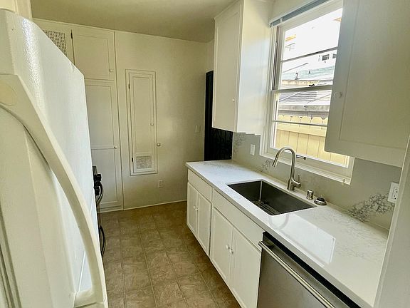 Kitchen with Dishwasher, Microwave, Ventilation Hood, and Gas Range
