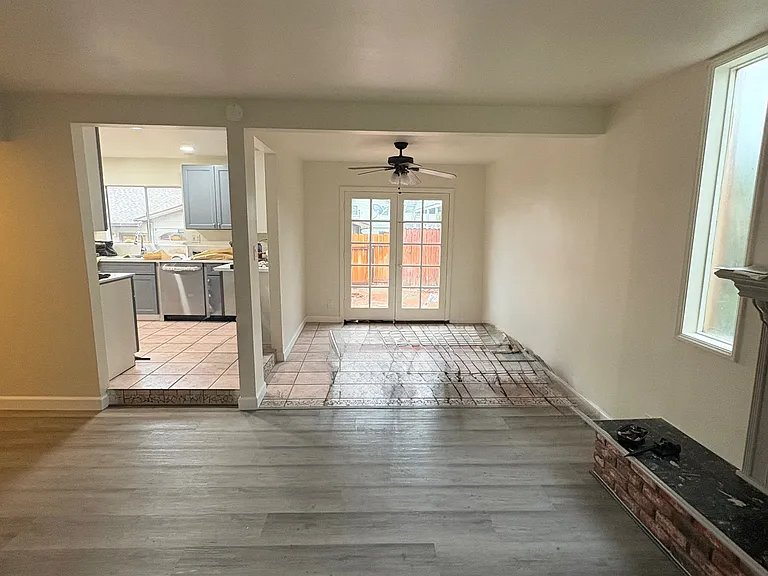 One more look across the living room, at the dining area on the right and kitchen on the left.