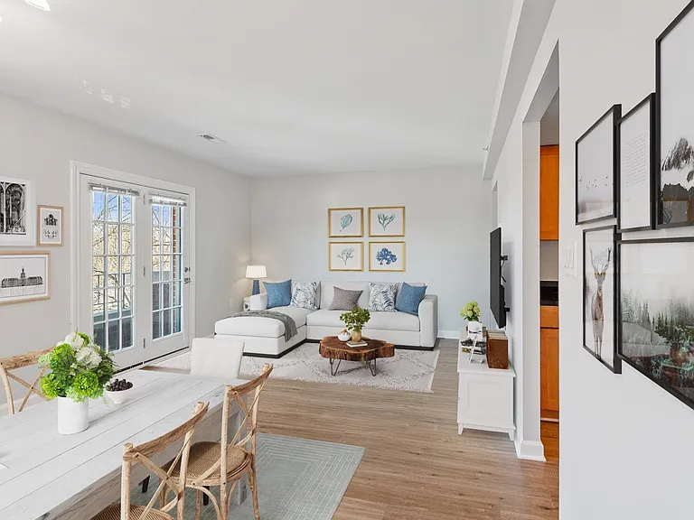Large living room with 8ft ceilings and wood flooring throughout