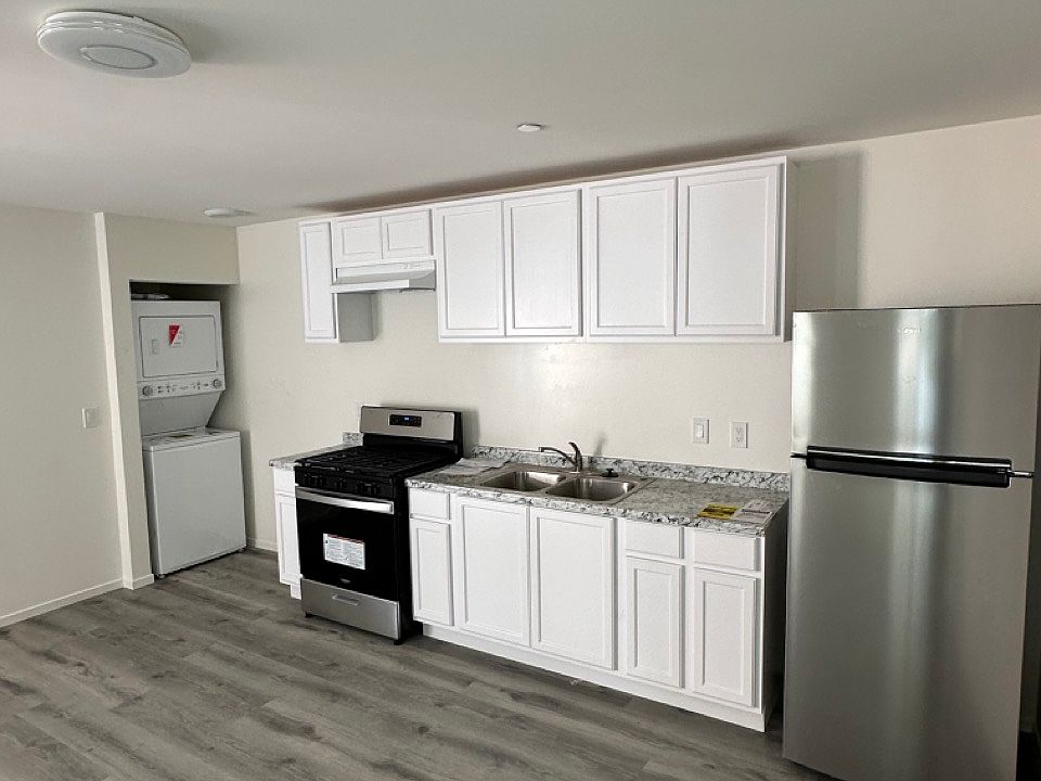 Living / dining / kitchen area with built in laundry