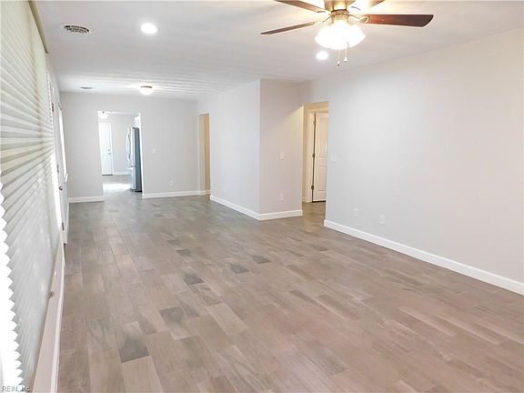 View of entire Living Room / Great Room from far wall looking toward the kitchen. Some owners might use this as a Living Room & Dining Area, others might use the whole space as a Living Room. Others might fit a home office on the shorter wall at upper center of photo. Design the space for you!