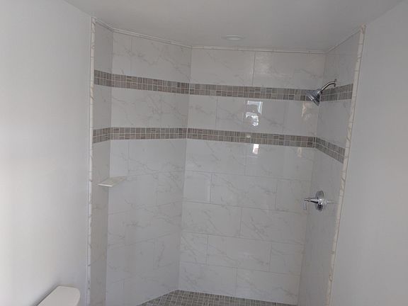New glass shower doors have been installed.