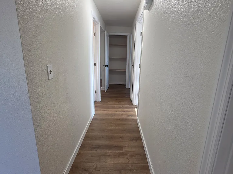 The LVP flooring continues down the hallway where the 3 bedrooms and bathroom are