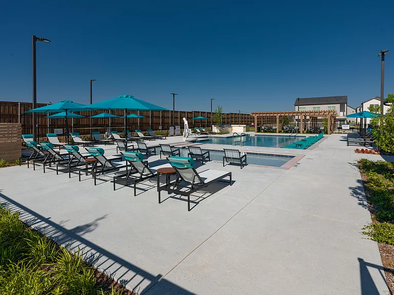 Resort-style swimming pool with lounge seating