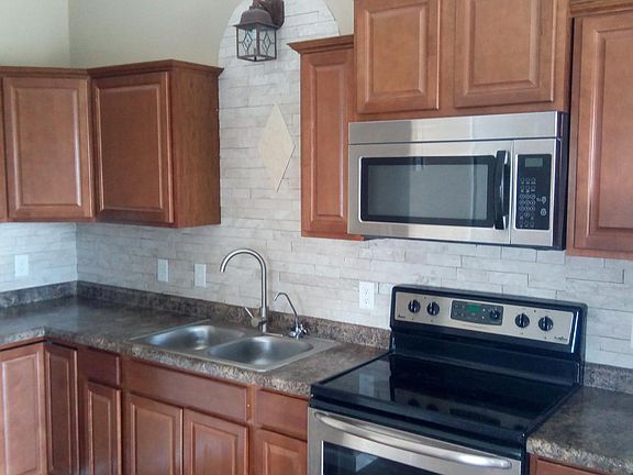 Hardwood cabinets with a lazy Susan in the corner.