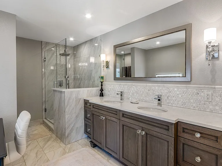 Massive renovation using the team at Wedgewood Designs and custom cabinetry, Marble and mother of pearl tile, rainfall shower, vanity, etc