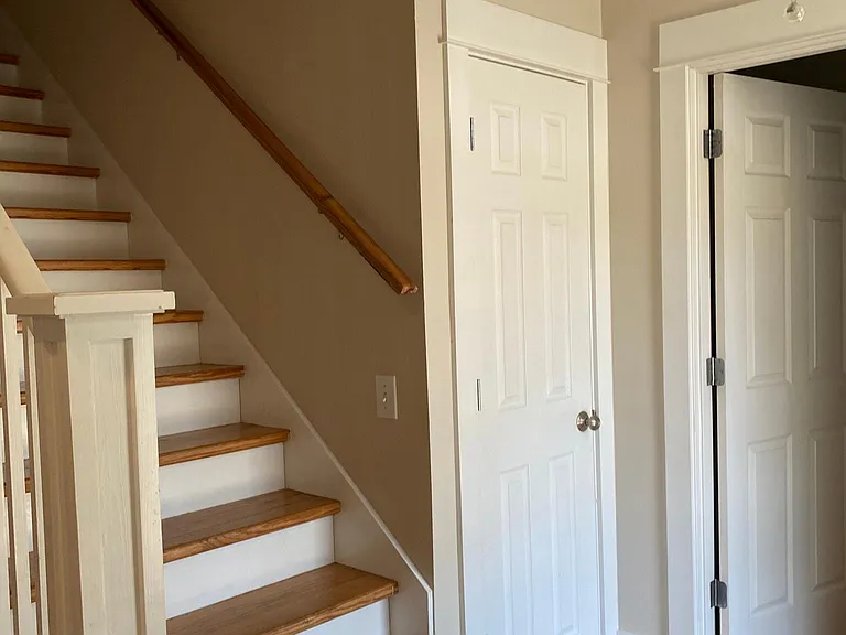 Entrance at front door, 1/2 bath to the right, closet, stairs