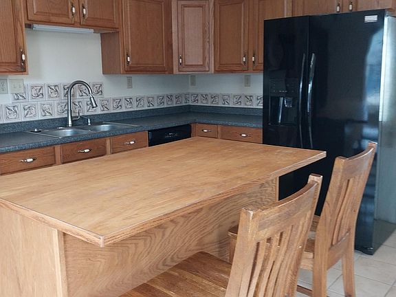 Kitchen with dishwasher, refrigerator, microwave and stove. And it has a pantry.