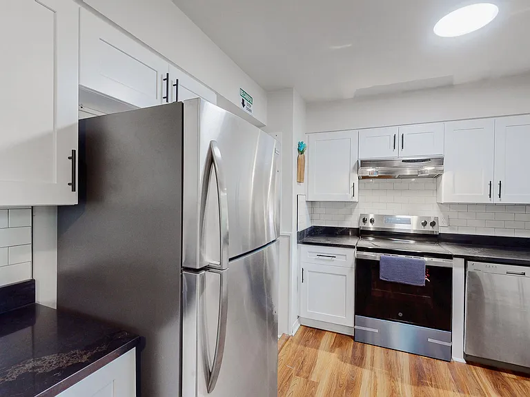 Updated kitchen with shaker cabinetry, stainless-steel appliances, and subway-tile backsplash with ample counter space.