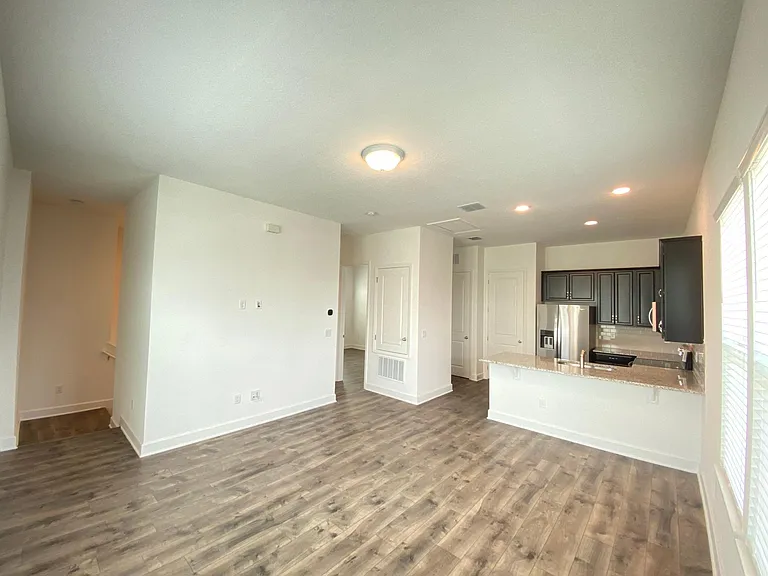 The view from the other side of the family room. The wall for the TV is on the left side and the kitchen is in the background to the right.