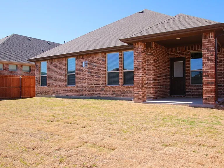 Large fenced backyard with covered patio