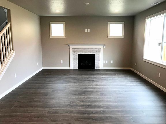 Great room with gas fireplace/fan, mantle pre-wired for TV, and lots of windows to let in natural light!
