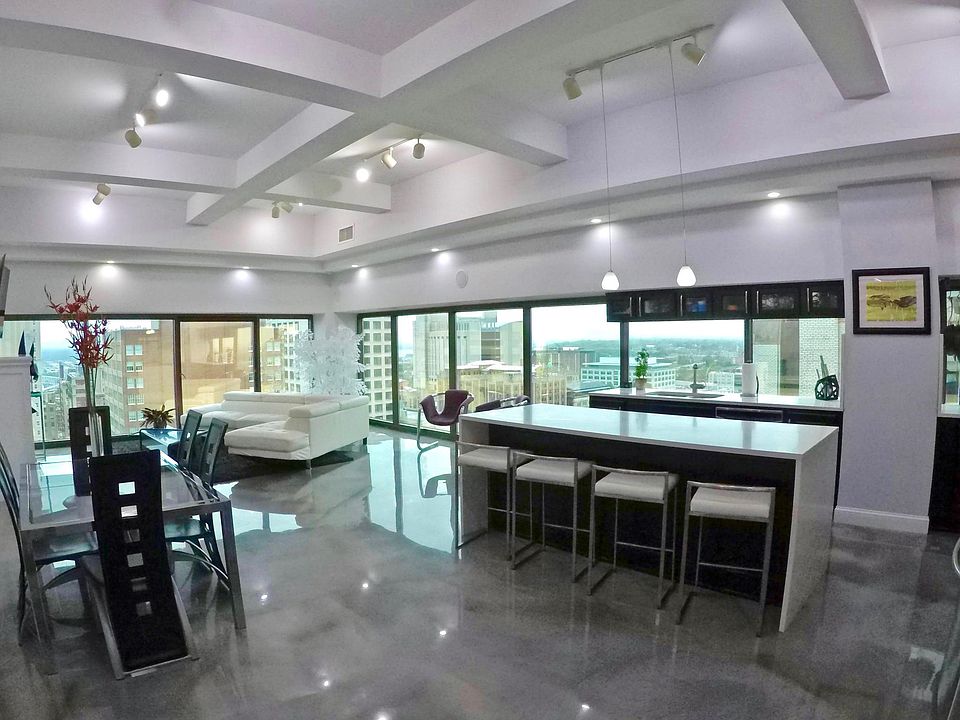 Soaring ceilings and a massive open floorplan, including an oversized island and expandable table for entertaining 8.