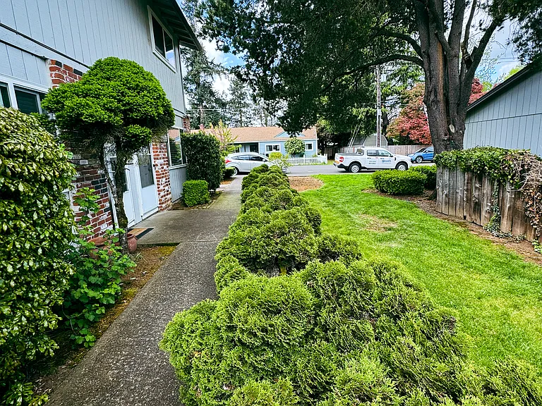 Walkway to this apartment. Quiet complex and safe neighborhood. Beautiful trees and bushes.