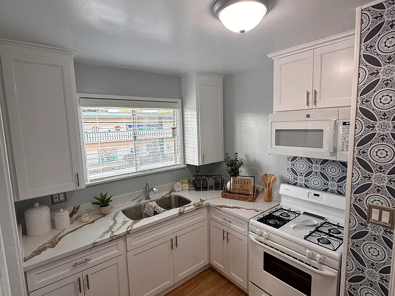 Custom Kitchen with quartz countertop and appliances.