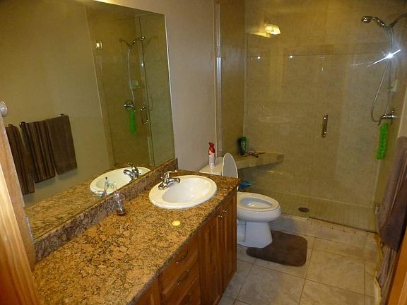 Lower level bathroom near washer/dryer and 2 bedrooms