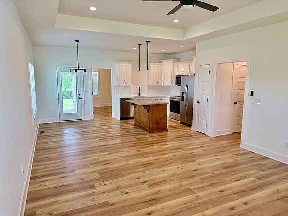 Enjoy the beautiful open-concept living room, kitchen and eating area.