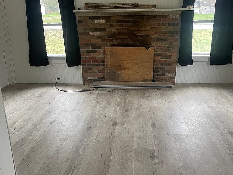 Living room with wood burning fireplace , view from kitchen