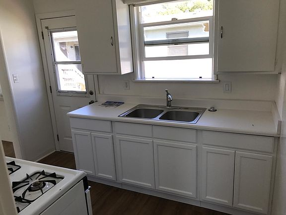 Kitchen with new bottom cabinets, counter, sink and faucet.