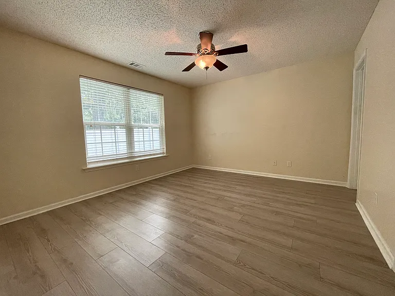 Large master bedroom with attached full bath and walk in closet