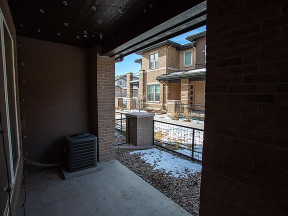 Fenced in patio with lights.