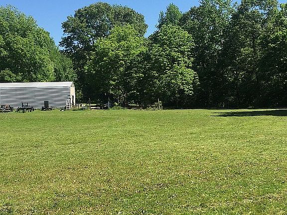 across field towards shop