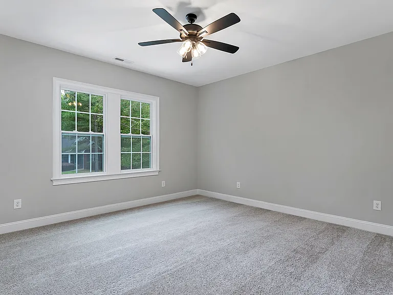 bedroom 2 with large closet and window