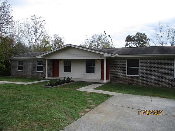 Cobblestone pathway leads up to your front door along with separate parking areas for both units