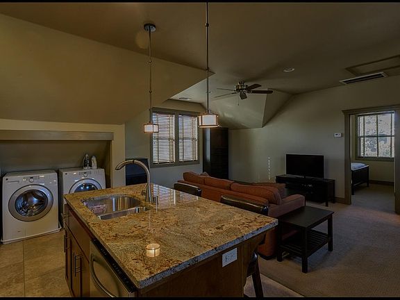 Kitchen toward living room and bedroom door. Washer and dryer closet has doors, not shown.