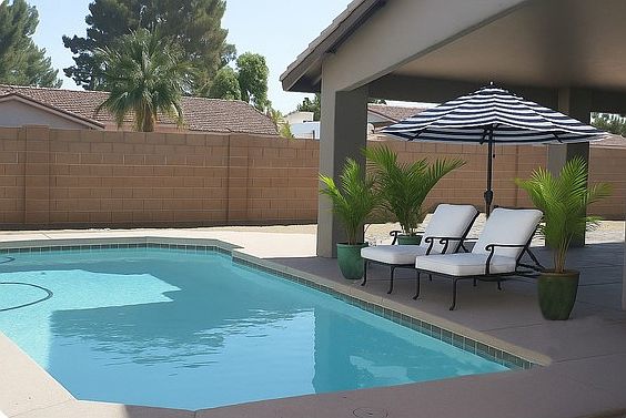 Pool and patio in late afternoon shade. Furnishings and plants not included.