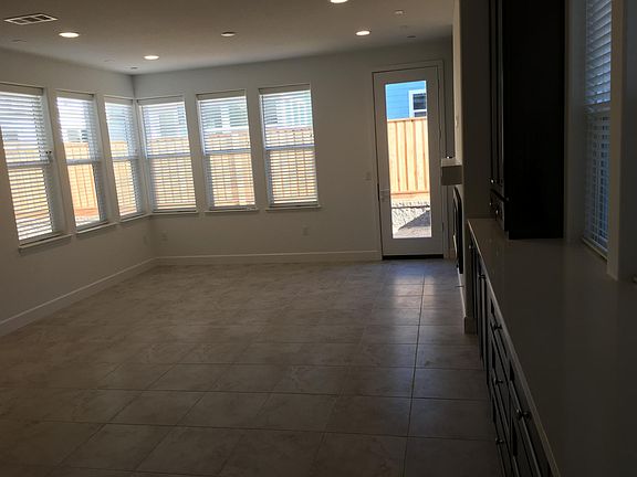 Living room. Back door opens to fenced yard with landscaped paver brick patio.