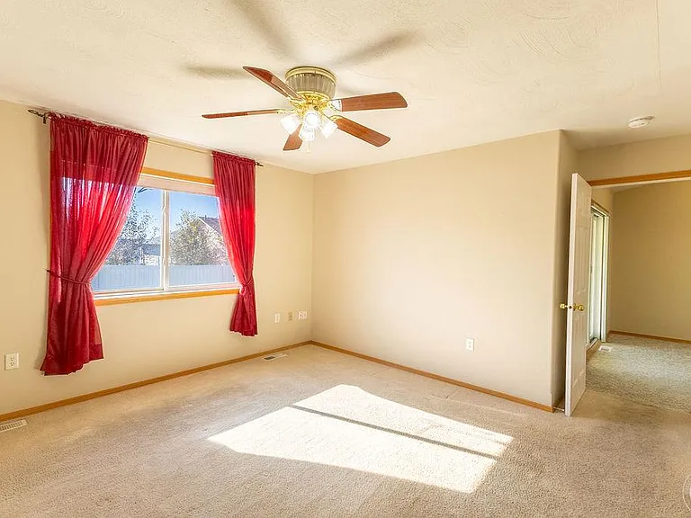Un-staged master bedroom suite, looks to dining room