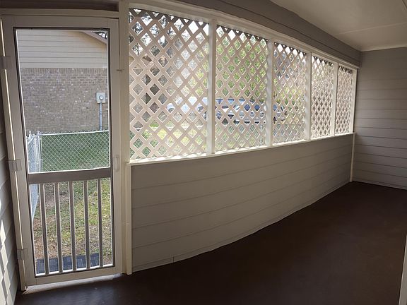 Cozy screened sunroom with privacy lattice.