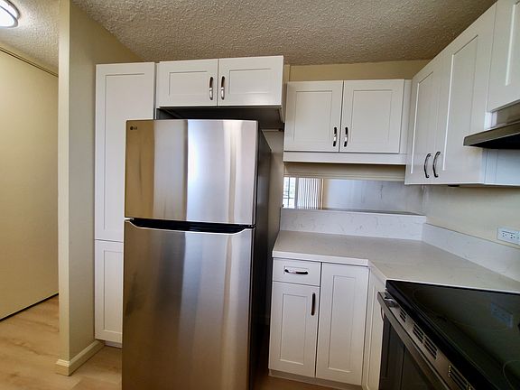 New stainless steel fridge, new cabinets with corner lazy susan, and bar counter
