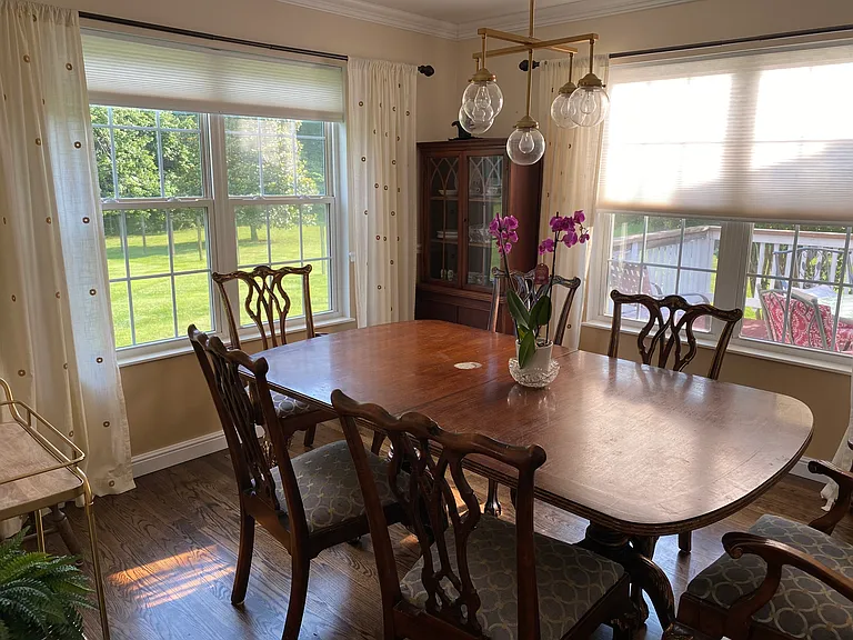 Plenty of light in the dining room overlooking the porch and yard