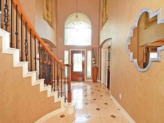 Notice the custom wrought iron ballisters as you enter this stately home.