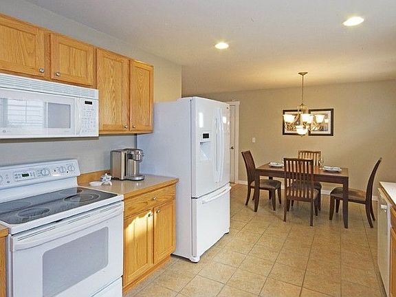 New refrigerator and Miele dishwasher in kitchen. Walk in pantry at the back of this room