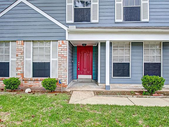 The covered porch is wide and is a great place for seating to relax and enjoy your new neighborhood. The burgundy front door invites you in to this great home. This home is a short walk from the community pool, park, walking path and sand volleyball 